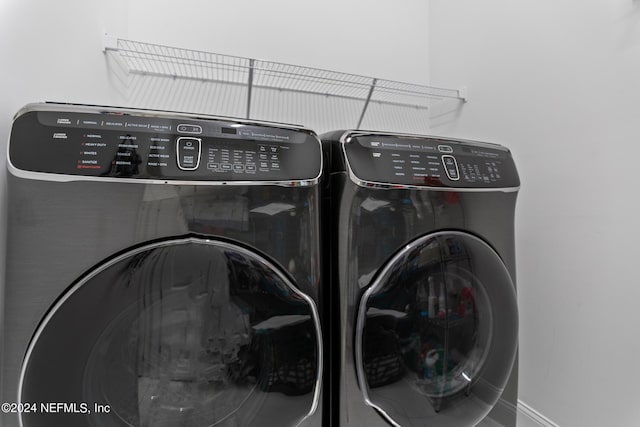 laundry room with washing machine and clothes dryer