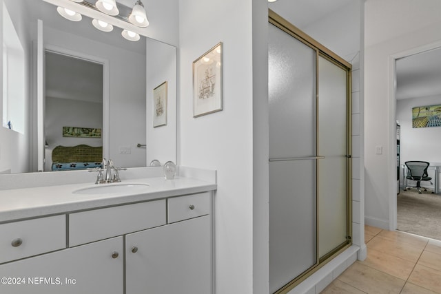 bathroom with vanity, an enclosed shower, and tile patterned floors