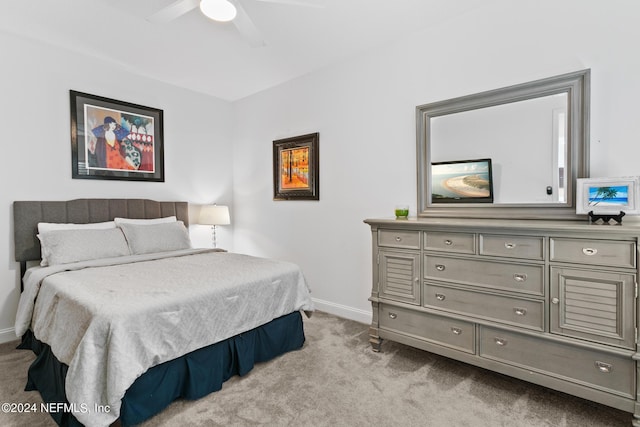 bedroom with light colored carpet and ceiling fan