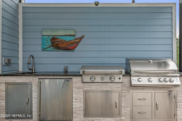 view of patio / terrace with an outdoor kitchen, sink, and grilling area