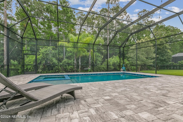 view of swimming pool with a lanai, a patio, and an in ground hot tub