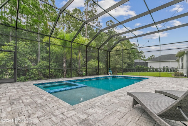 view of swimming pool featuring a yard, a lanai, a patio, and an in ground hot tub