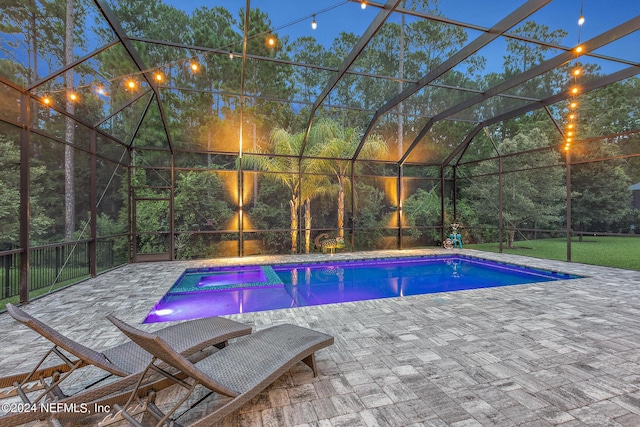 view of swimming pool with a patio area and glass enclosure