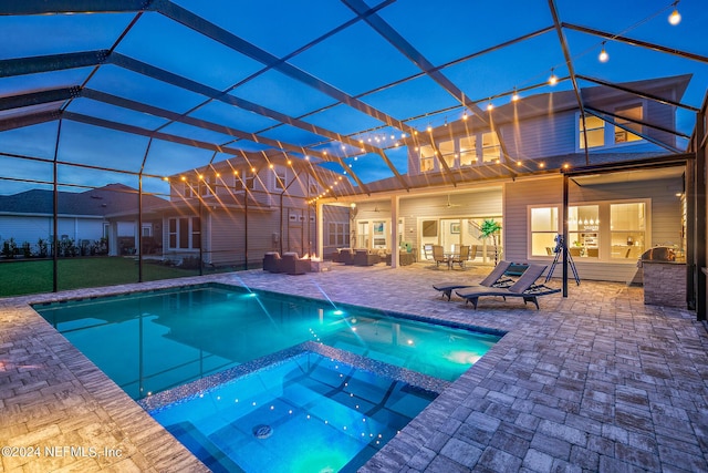 view of pool featuring an in ground hot tub, an outdoor living space, a lanai, and a patio area