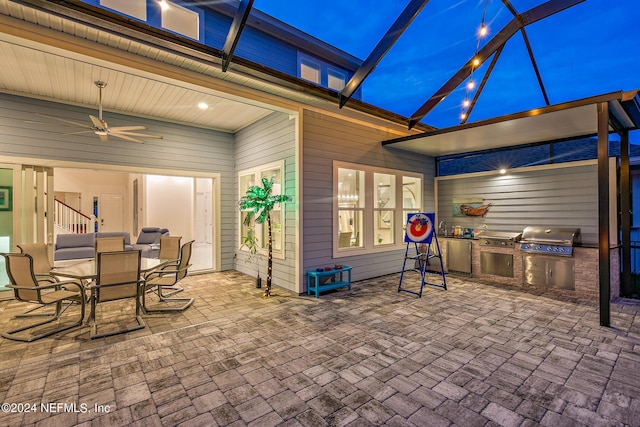 view of patio / terrace featuring ceiling fan, area for grilling, and a lanai