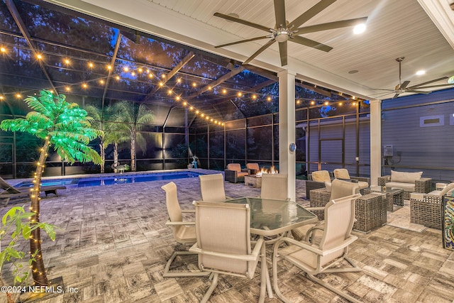 view of swimming pool featuring a lanai, an outdoor hangout area, and ceiling fan