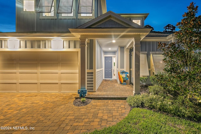 doorway to property with a garage