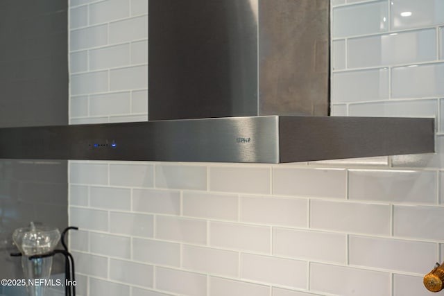 room details with wall chimney range hood