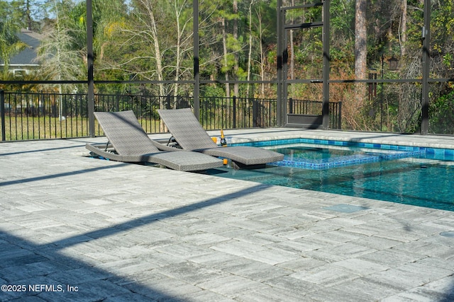 view of pool with a hot tub and a patio