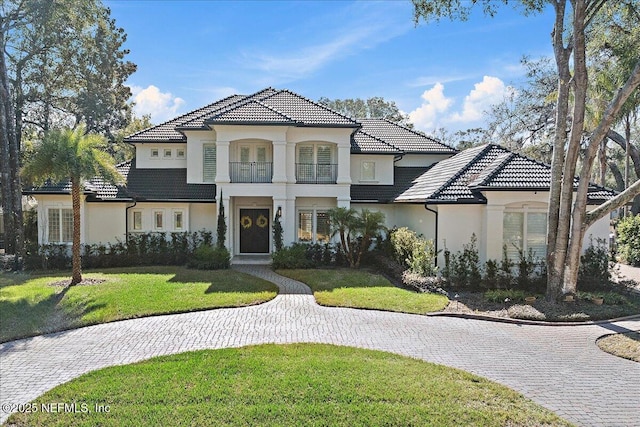 mediterranean / spanish home featuring a front yard