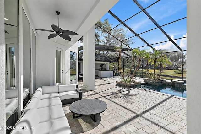 view of patio with ceiling fan, a swimming pool with hot tub, a lanai, and an outdoor hangout area