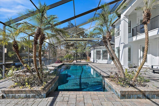 view of pool featuring a patio and glass enclosure