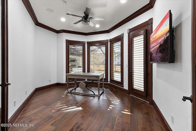 home office featuring crown molding, dark wood-type flooring, and ceiling fan