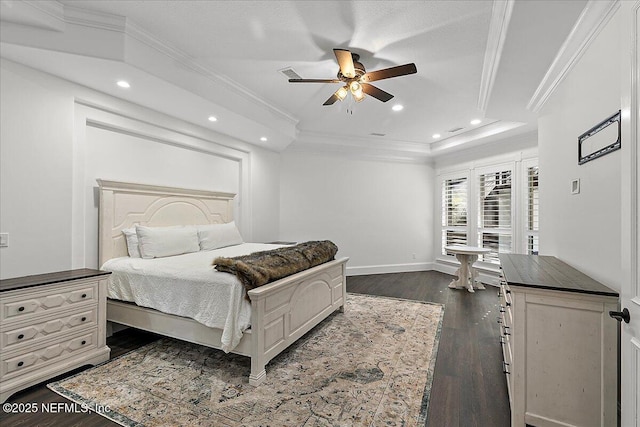 bedroom with ornamental molding, ceiling fan, dark hardwood / wood-style flooring, and a tray ceiling