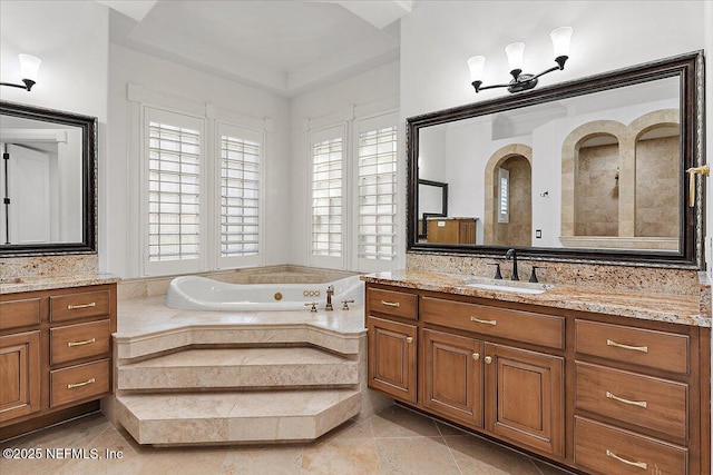 bathroom with vanity, a relaxing tiled tub, and tile patterned floors