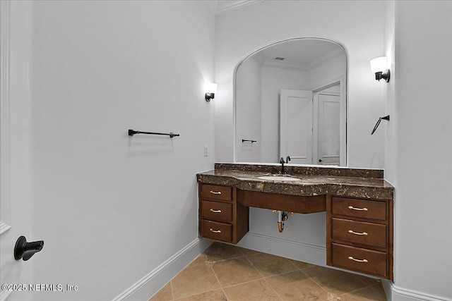 bathroom featuring crown molding and sink