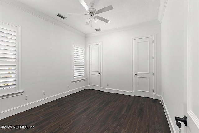 unfurnished room with crown molding, dark wood-type flooring, ceiling fan, and a wealth of natural light