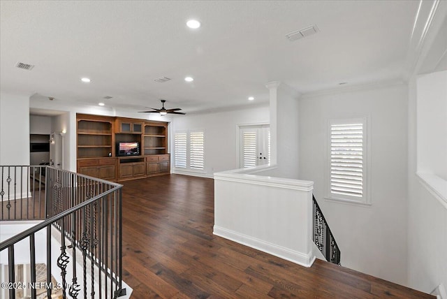 interior space with crown molding, ceiling fan, and dark hardwood / wood-style flooring