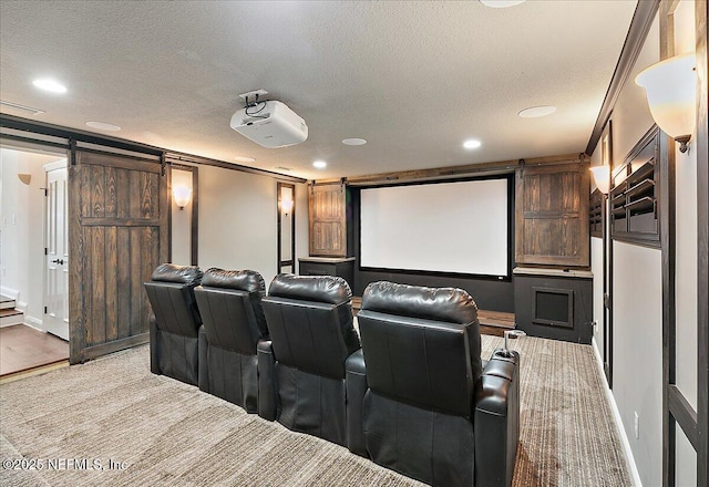 home theater room featuring crown molding, a barn door, and a textured ceiling