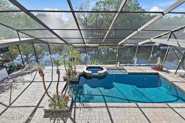 view of pool with an in ground hot tub, a water view, a lanai, and a patio area