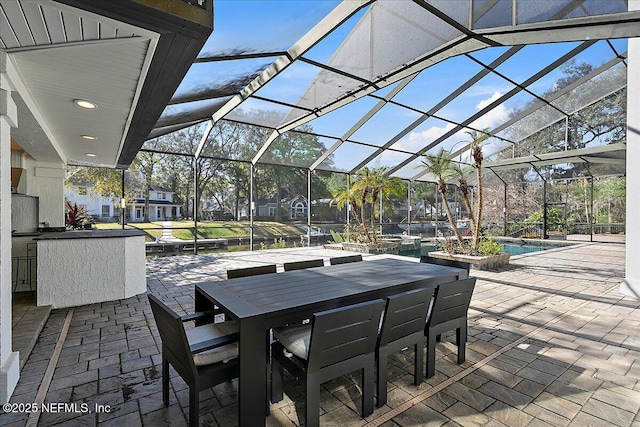 view of patio featuring a lanai