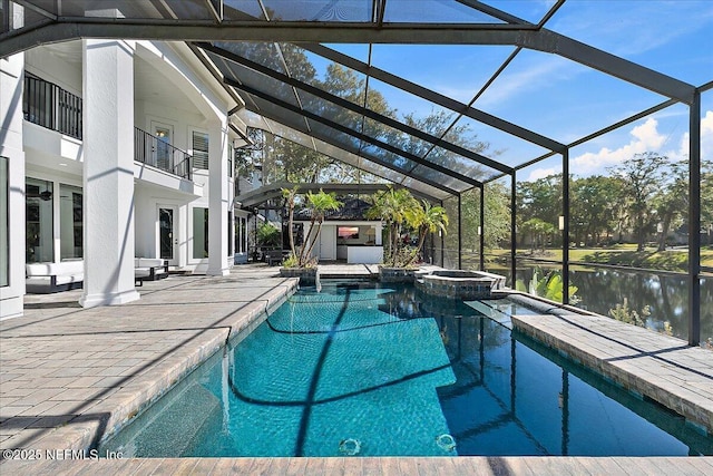 view of swimming pool with an in ground hot tub, a water view, glass enclosure, and a patio