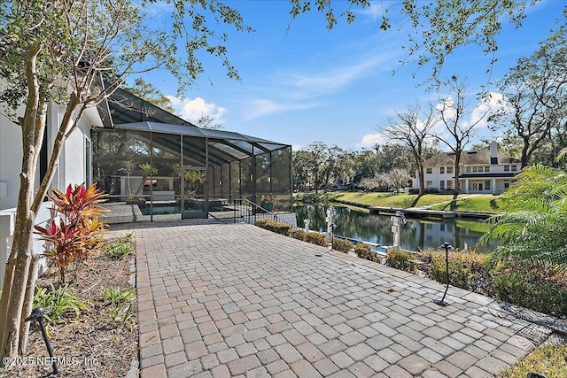 view of patio / terrace with a water view and a lanai