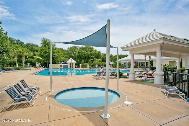 view of pool with a gazebo, a community hot tub, and a patio area