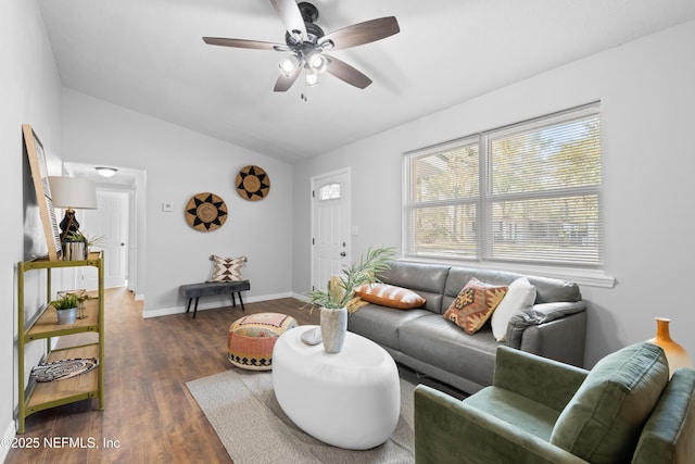 living room featuring ceiling fan, lofted ceiling, and dark hardwood / wood-style floors