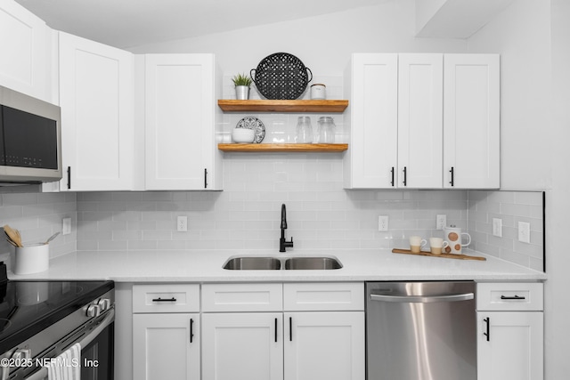 kitchen with white cabinets and appliances with stainless steel finishes