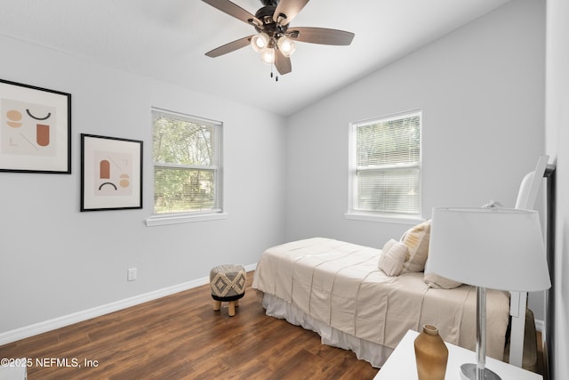 bedroom with vaulted ceiling, ceiling fan, and dark hardwood / wood-style flooring