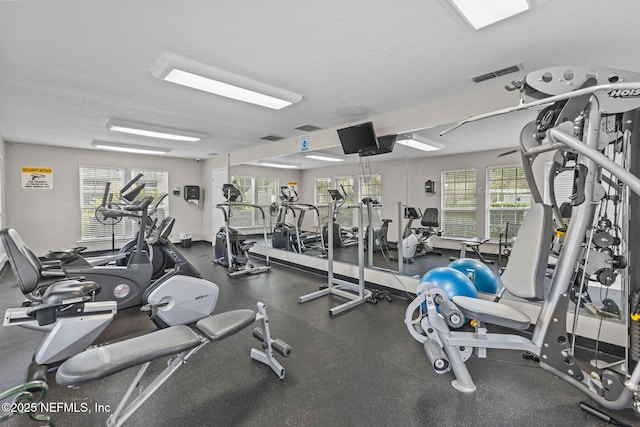 workout area featuring a healthy amount of sunlight and a textured ceiling