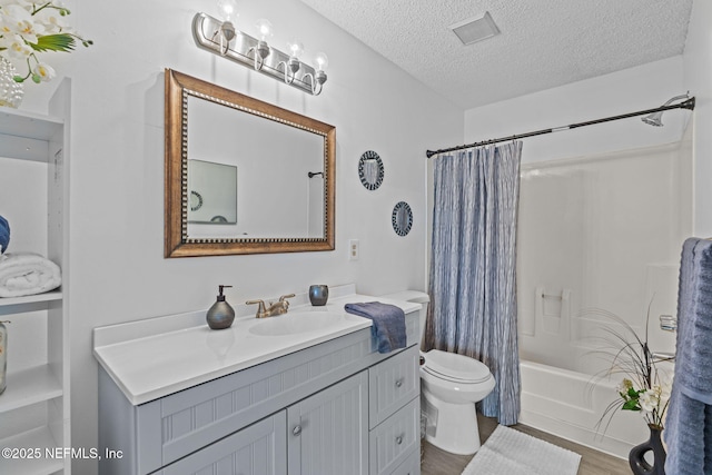 full bathroom featuring shower / tub combo with curtain, vanity, wood-type flooring, a textured ceiling, and toilet