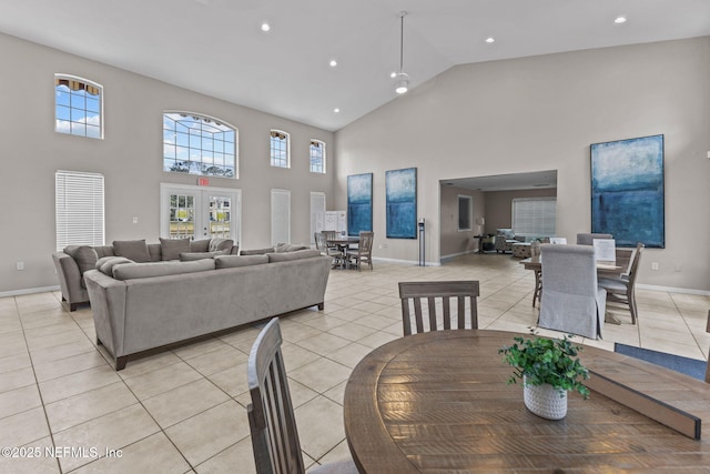 tiled dining room with french doors and high vaulted ceiling