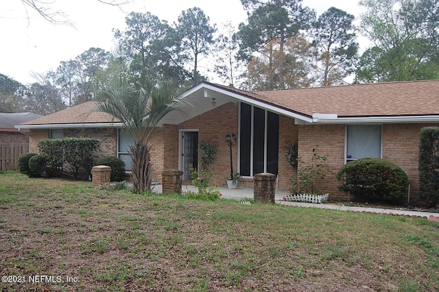 ranch-style home featuring a front yard