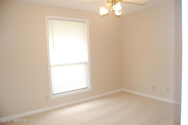 unfurnished room with ceiling fan and carpet floors