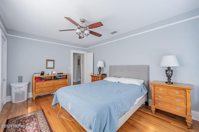 bedroom with ceiling fan and light hardwood / wood-style flooring