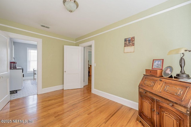 interior space with light hardwood / wood-style flooring and ornamental molding