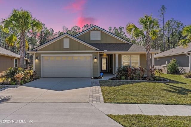 view of front of house featuring a garage and a yard