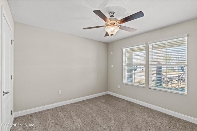 spare room with ceiling fan, carpet floors, and a textured ceiling