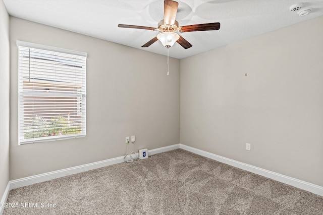 carpeted spare room with a textured ceiling and ceiling fan