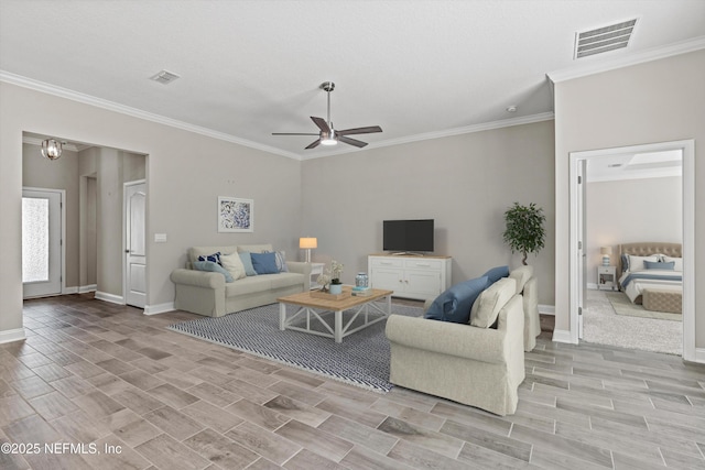 living room featuring ornamental molding and ceiling fan