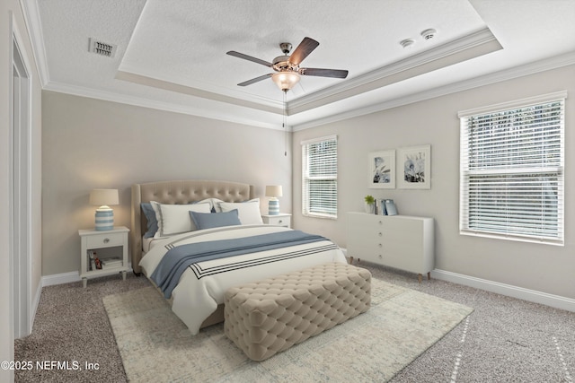 bedroom featuring a raised ceiling, ornamental molding, and a textured ceiling