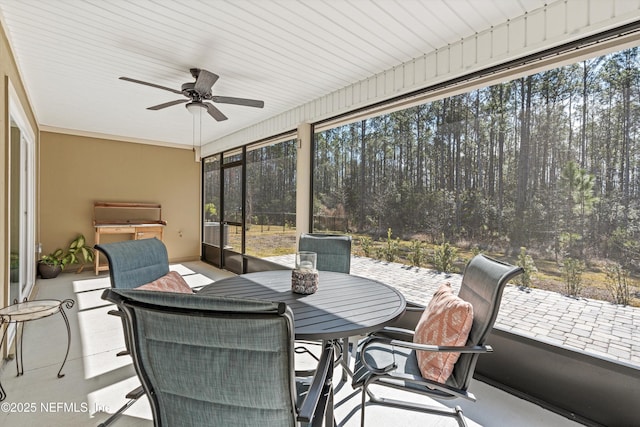 sunroom / solarium featuring ceiling fan