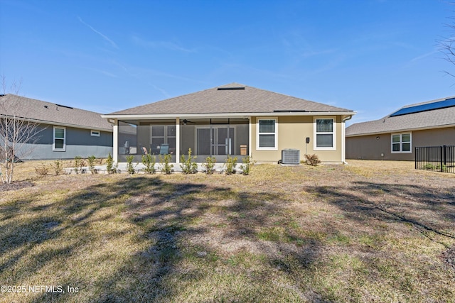 back of house featuring cooling unit, a yard, and a sunroom