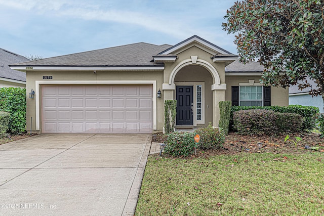 view of front of property with a garage and a front lawn