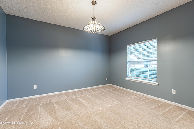 empty room with carpet flooring and a textured ceiling