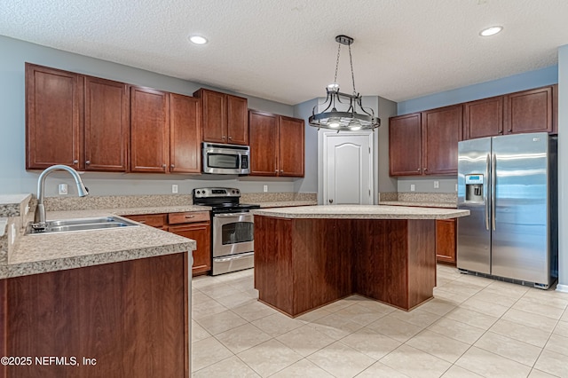 kitchen with appliances with stainless steel finishes, pendant lighting, sink, a center island, and light tile patterned floors