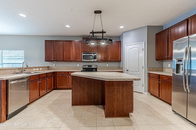 kitchen featuring sink, hanging light fixtures, a kitchen island, stainless steel appliances, and light tile patterned flooring