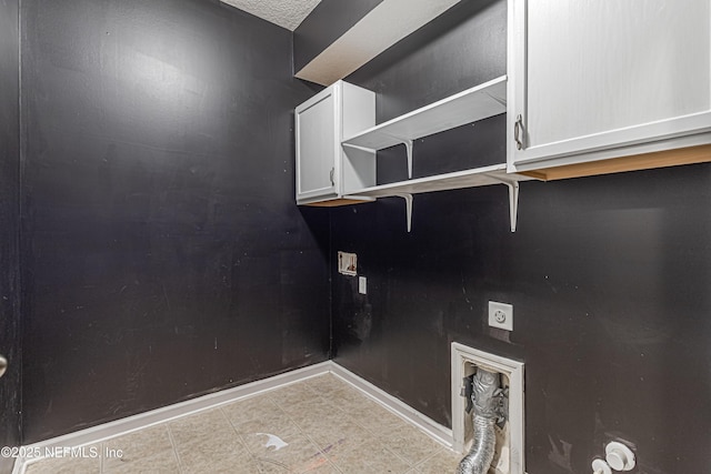 clothes washing area featuring hookup for a washing machine, hookup for an electric dryer, and cabinets